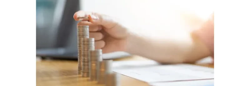 A stack of coins symbolizing the pros and cons of Wix vs. Shopify