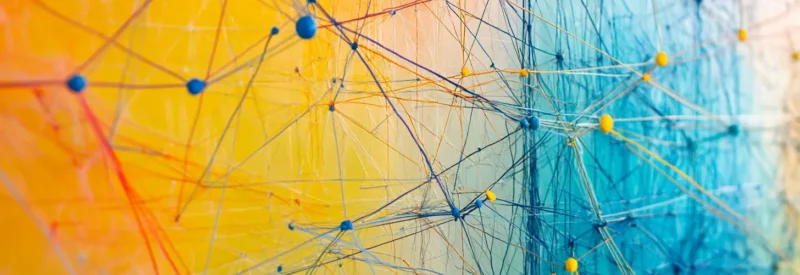 An abstract representation of interconnected networks with blue and yellow strings linking various nodes, symbolizing software integrations and digital connectivity.