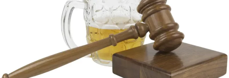 A gavel and a beer in a glass sold through a liquor license in Indiana.