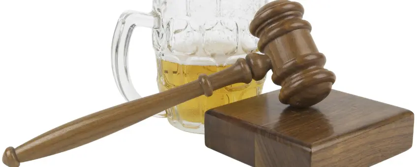 A gavel and a beer in a glass sold through a liquor license in Indiana.