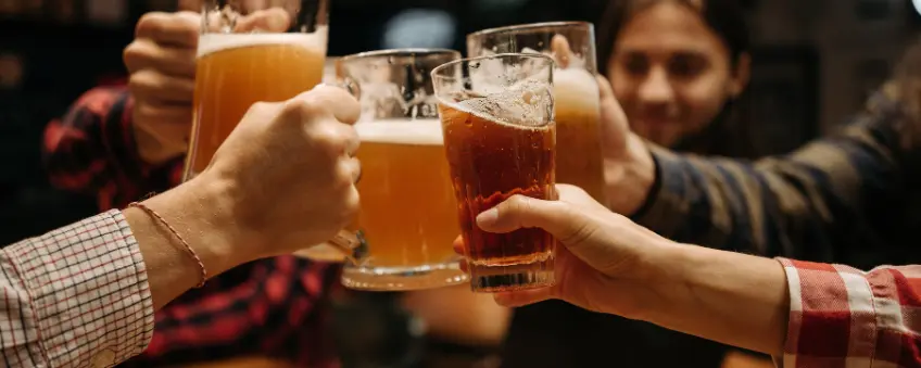 Patrons cheers'ing beers at an Illinois bar that has a functioning liquor license.