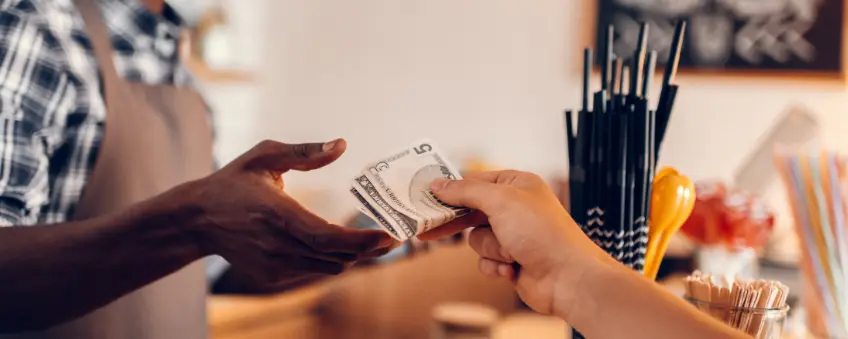 A man buying coffee through a cash discount program.