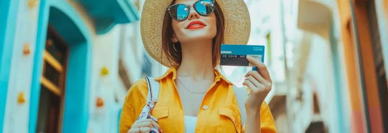 a tourist in a foreign country holding a credit card