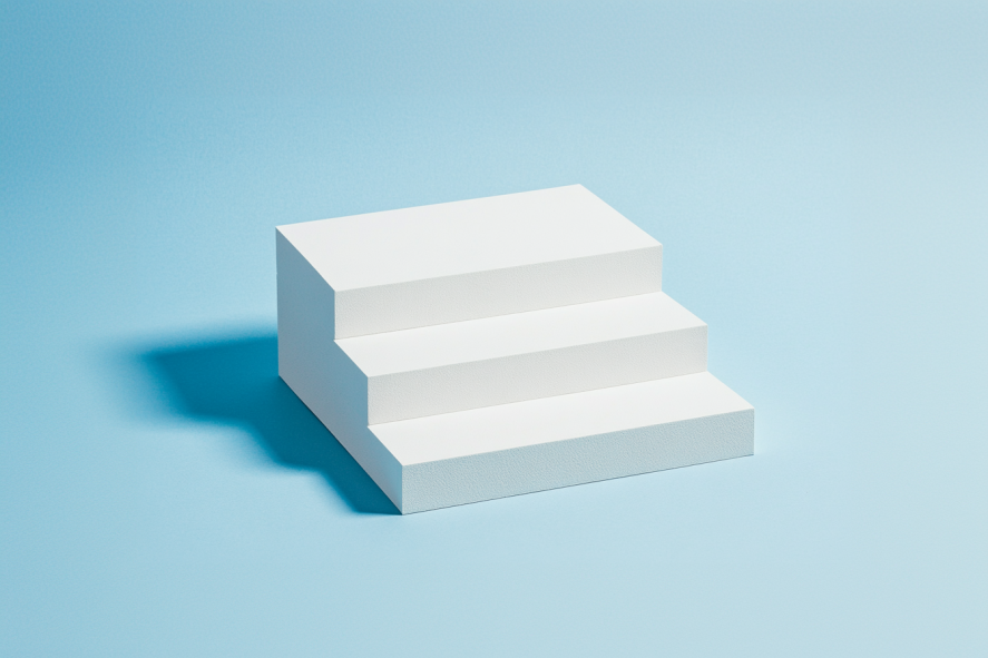 White minimalist stairs with three steps on a light blue background.