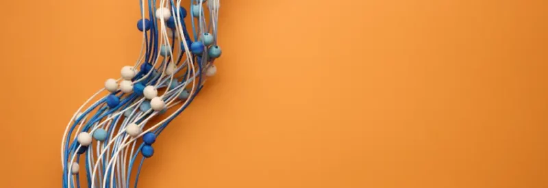 blue and white balls along wavy strings representing ISV connection to cloud-based services against an orange background