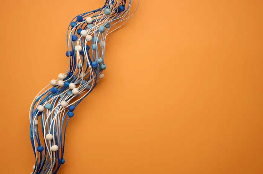 blue and white balls along wavy strings representing ISV connection to cloud-based services against an orange background
