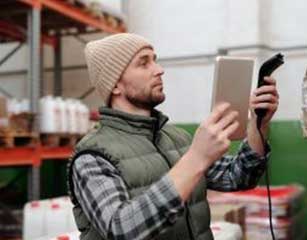 business owner scanning inventory in warehouse